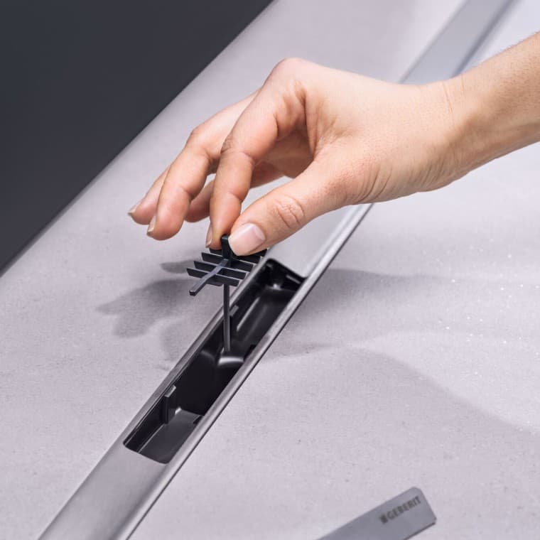 Met de hand een kam-inzetstuk in de afvoer plaatsen Met de hand een kam-inzetstuk in de afvoer plaatsen