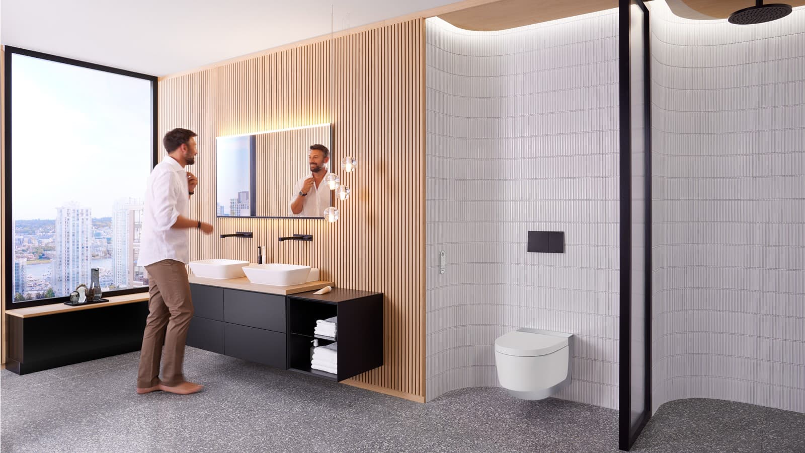 Man in badkamer staand voor Geberit Option Plus Square spiegel en zwart Geberit ONE badkamermeubilair (© Geberit) Man in badkamer staand voor Geberit Option Plus Square spiegel en zwart Geberit ONE badkamermeubilair (© Geberit)